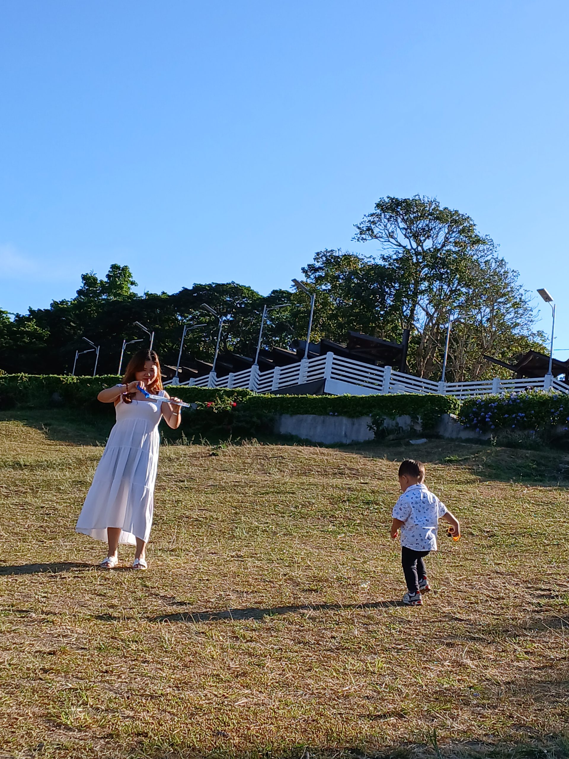 mom and kid playing in the field